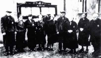 Ten people in coats, some looking at the camera, some away from it.