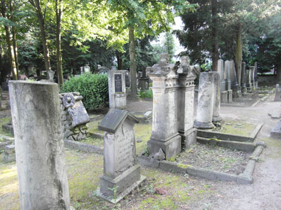 Several light gravestones and half columns