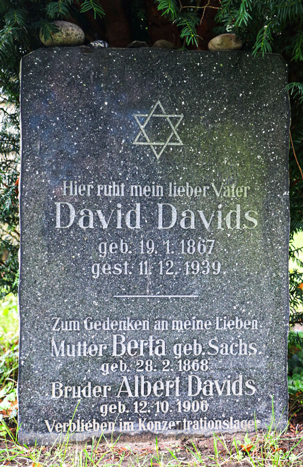 Black gravestone with engraved script; at the top, a Star of David.